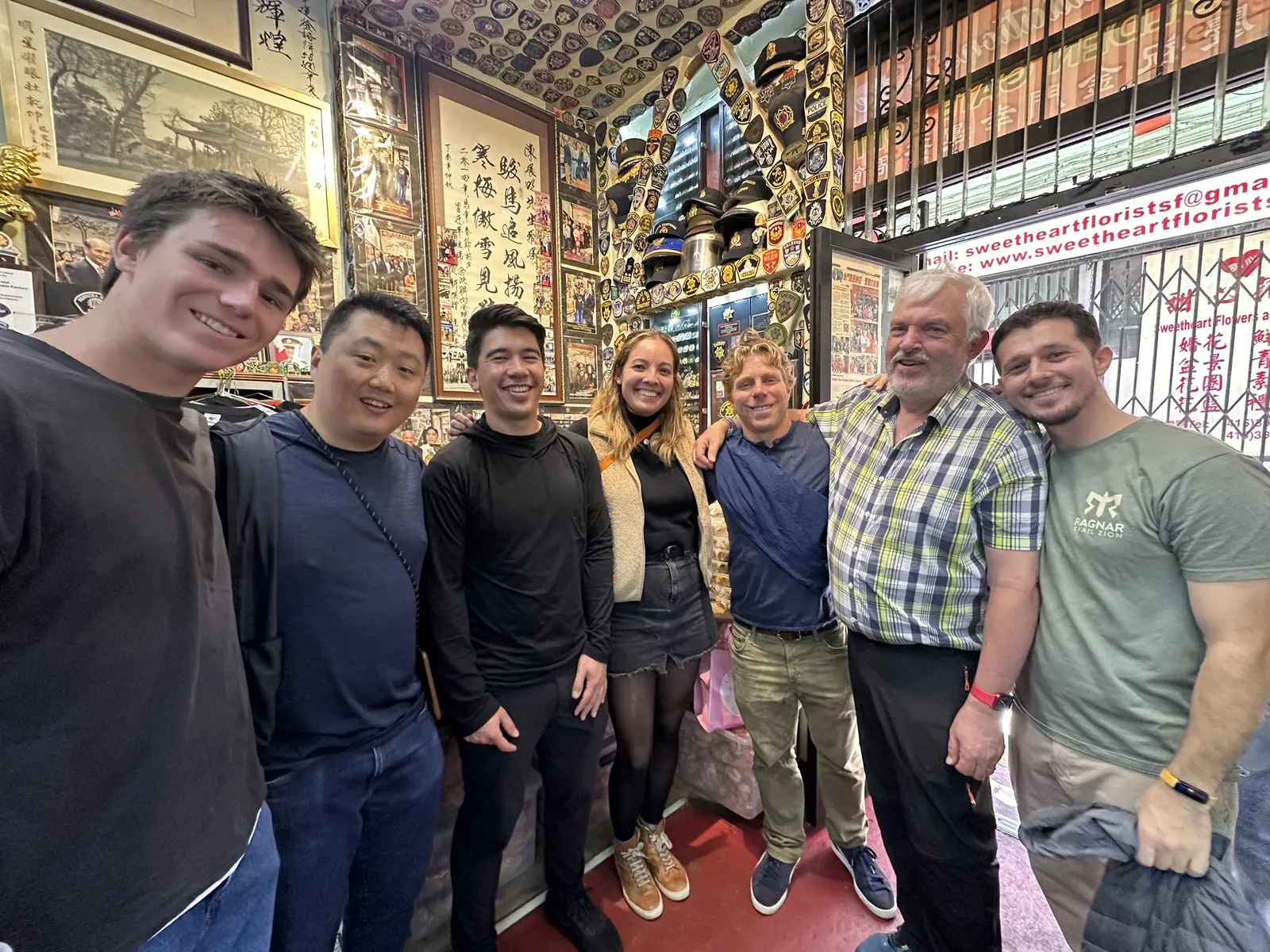 The team surrounded by law-enforcement patches at a shop in San Francisco