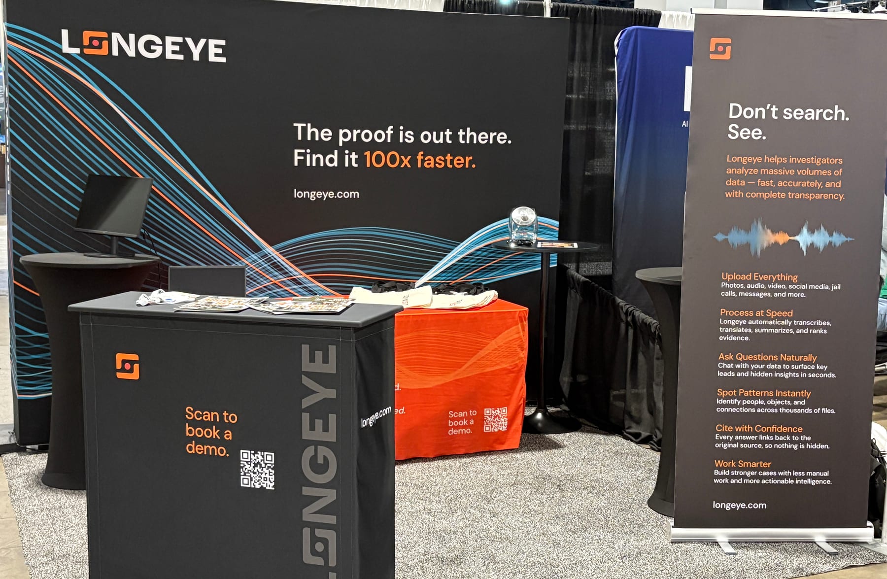 Longeye booth at IACP Tech, Booth 629. Black backdrop reading 'The proof is out there. Find it 100x faster.' with an orange counter and 'Scan to book a demo' QR code.